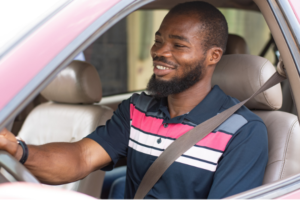 Images shows a young man smiling while driving. The text paired with the image reads "One of the most significant reforms  Virginia has made is to stop  suspending driver’s license due to unpaid fines and fees. 
The practice was a clear example 
of how fines and fees often trap 
people into cycles of poverty and 
keep them tethered to the criminal 
legal system."