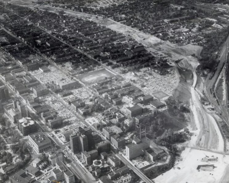 A large dirt path that would be a turnpike cuts through and sits right next to neighborhoods of houses