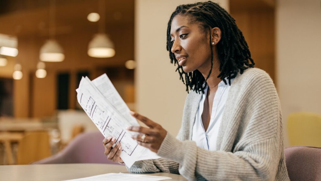 A woman looks through accounting paperwork.